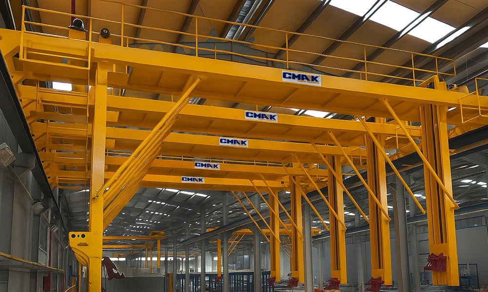A multi-stage automated surface treatment facility featuring yellow overhead process cranes from the special cranes CMAK series, handling aluminum extrusion profiles over chemical dipping tanks.